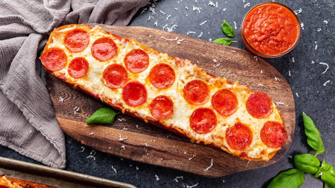 Overhead view of French bread pizza uncut.